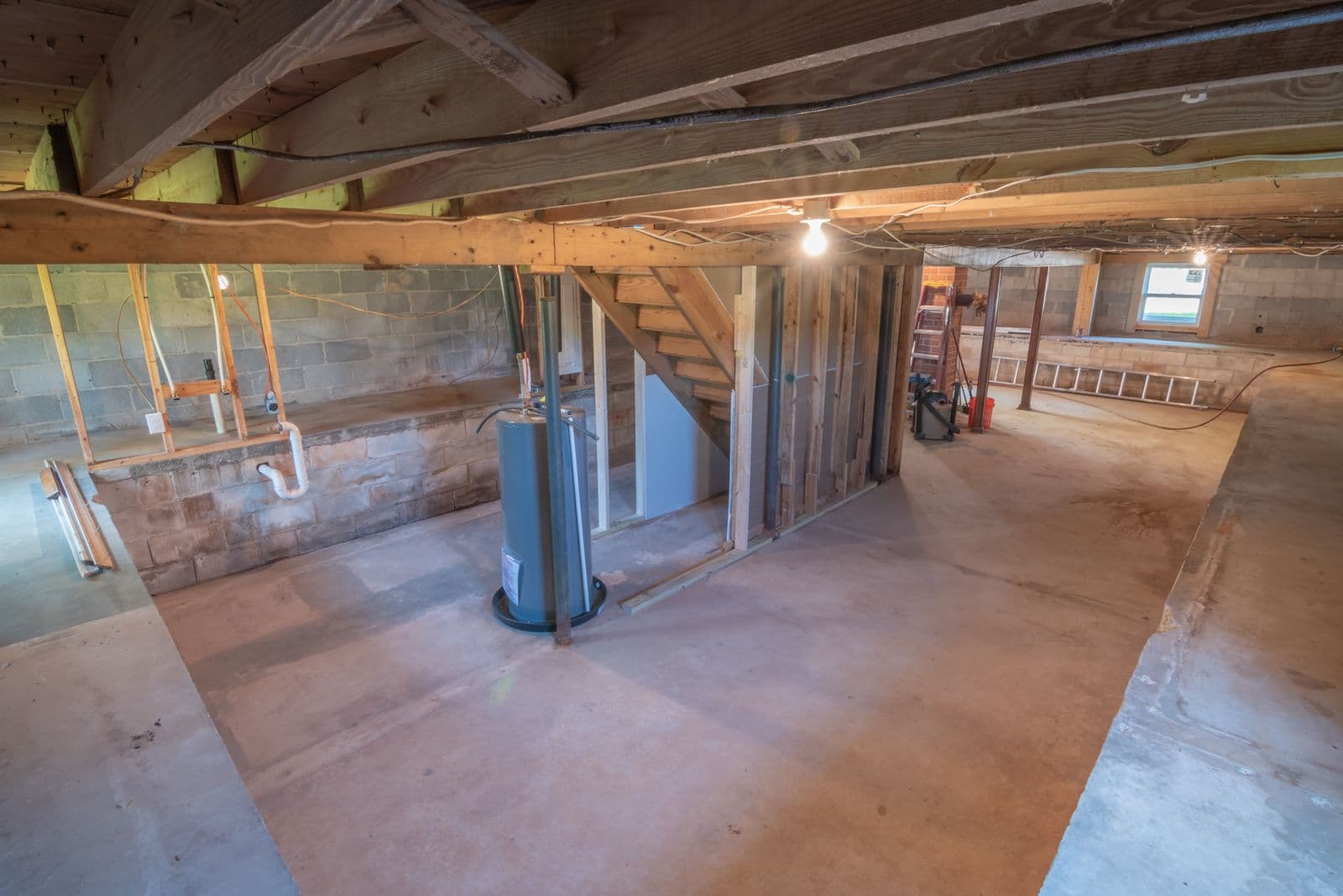 Unfinished basement with exposed beams and pipes